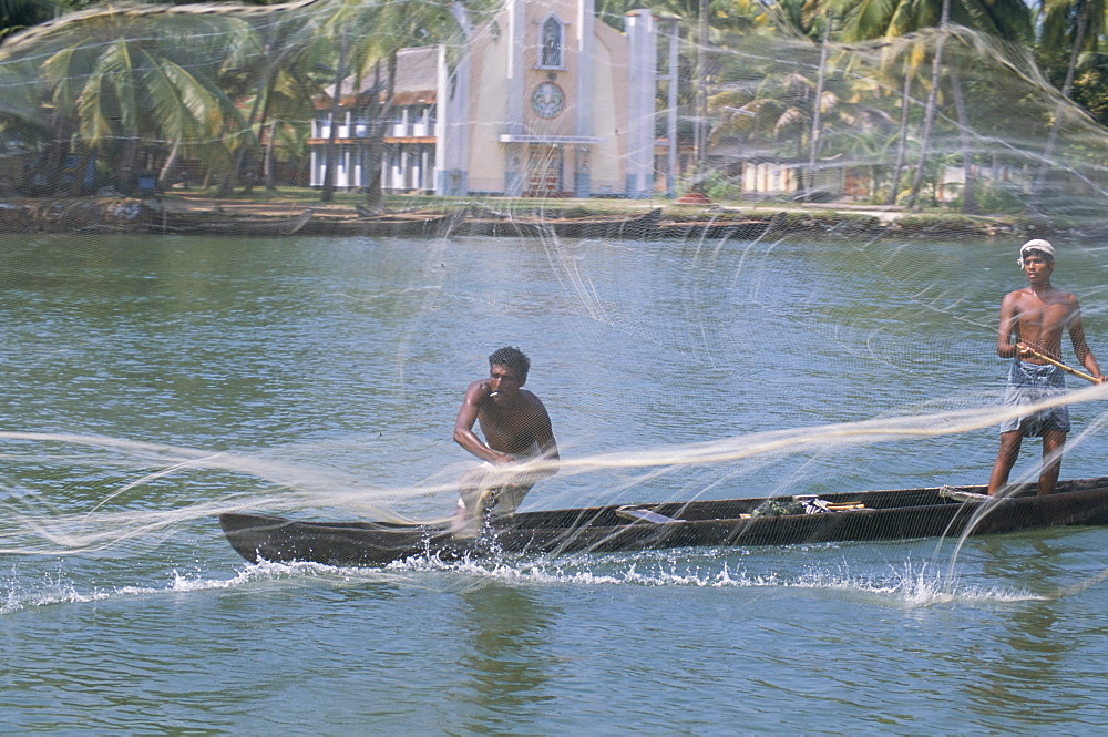 Fisherman casting his throw net in the coastal backwaters, Kerala, India, Asia