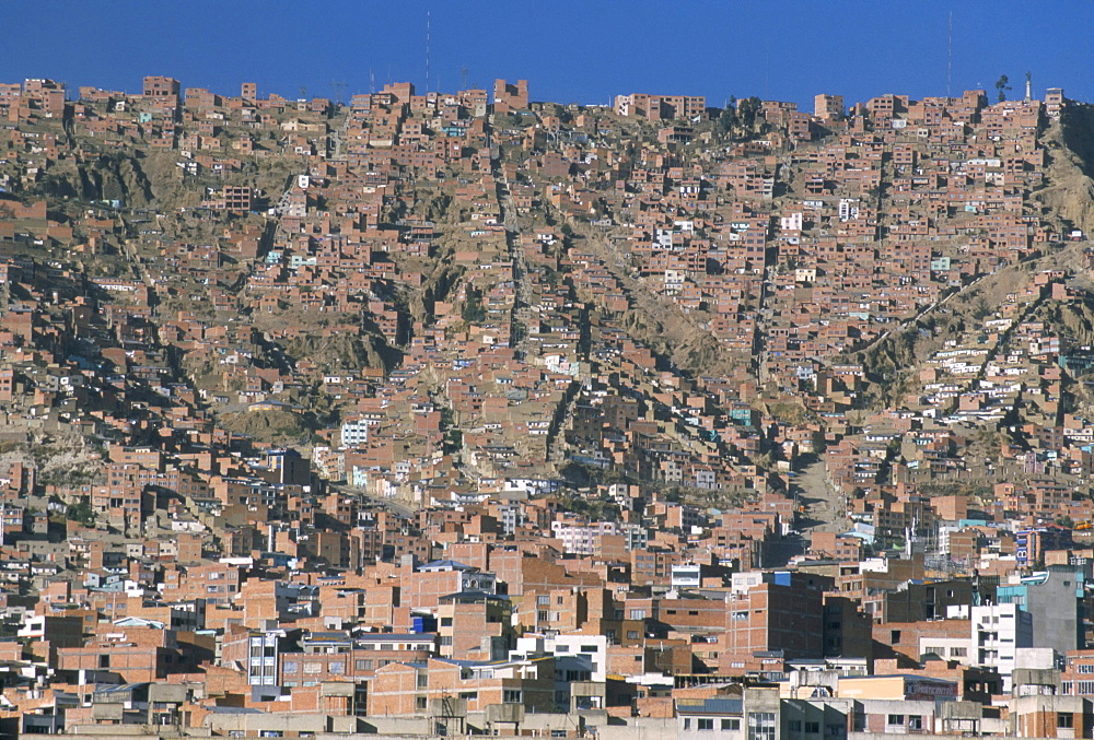 View across city from El Alto, of suburb houses stacked up hillside, La Paz, Bolivia