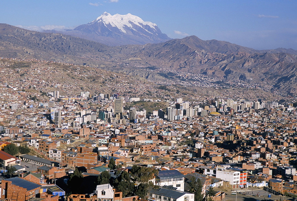 View across city from El Alto, with Illimani volcano in distance, La Paz, Bolivia, South America