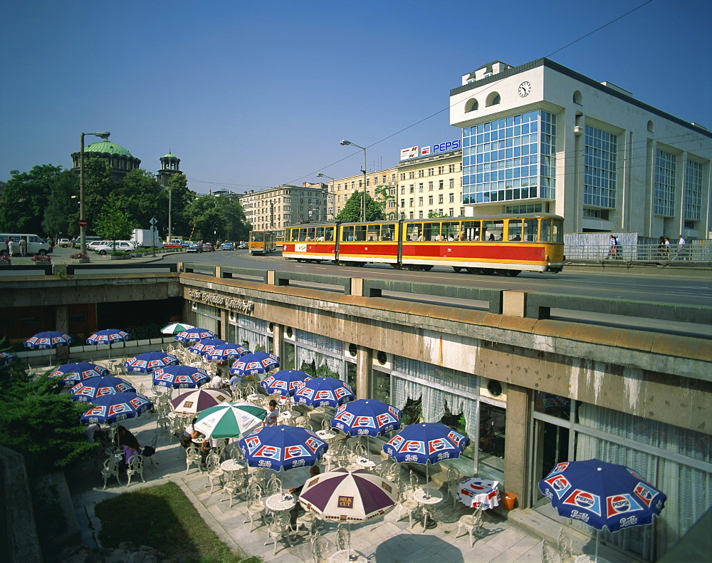 Trams running close to a cafe on G Dimitrov Street in Sofia, Bulgaria, Europe