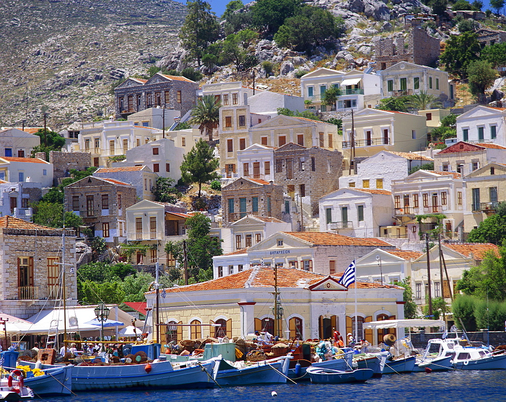 Moored boats and waterfront buildings, Gialos, Symi (Simi), Dodecanese Islands, Greece 