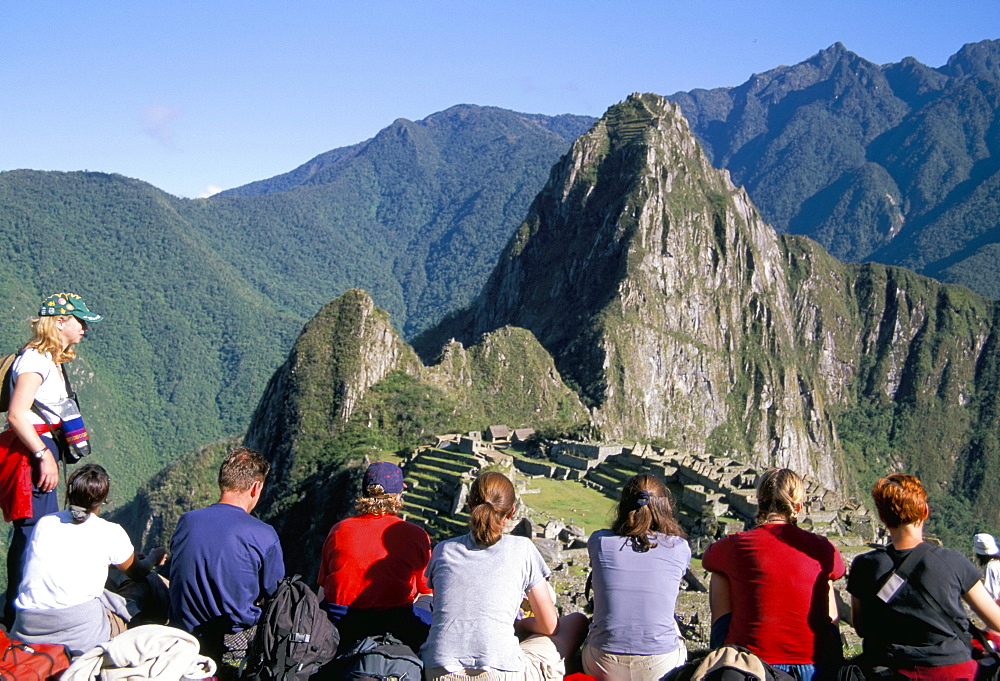 Tourists looking out over Machu Picchu, UNESCO World Heritage Site, Peru, South America