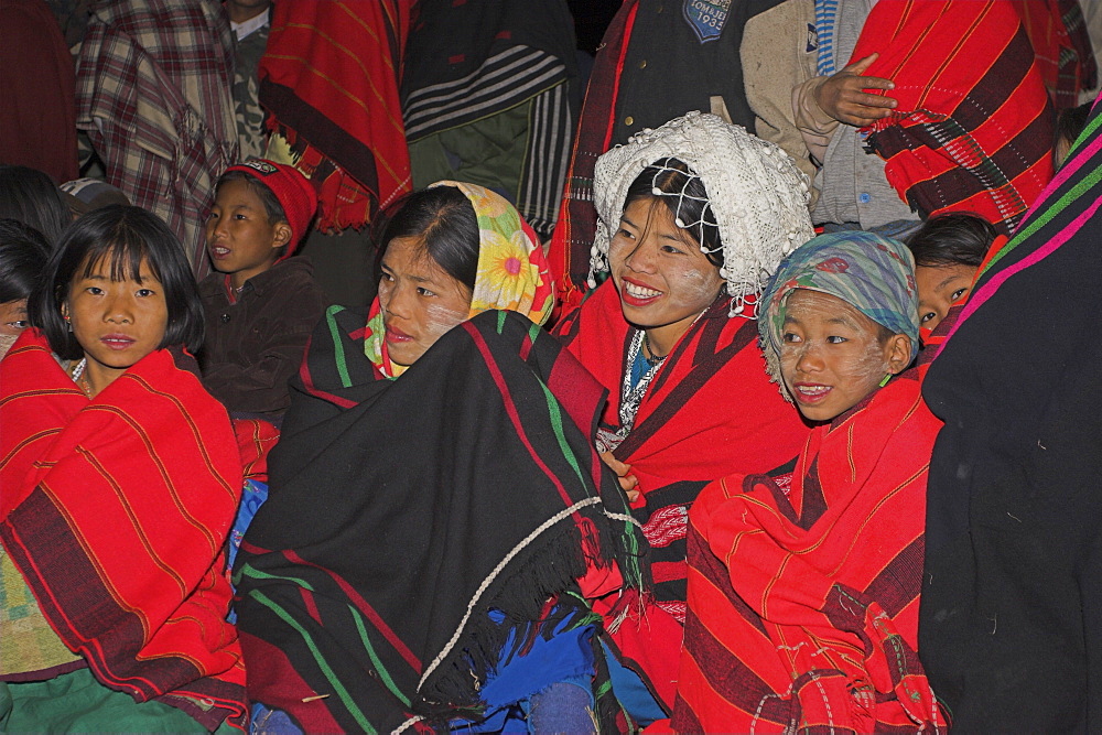 Naga people wrapped up in traditional blankets watching the Grand Finale - tribal dancing round a bonfire, Naga New Year Festival, Lahe village, Sagaing Division,  Myanmar (Burma), Asia