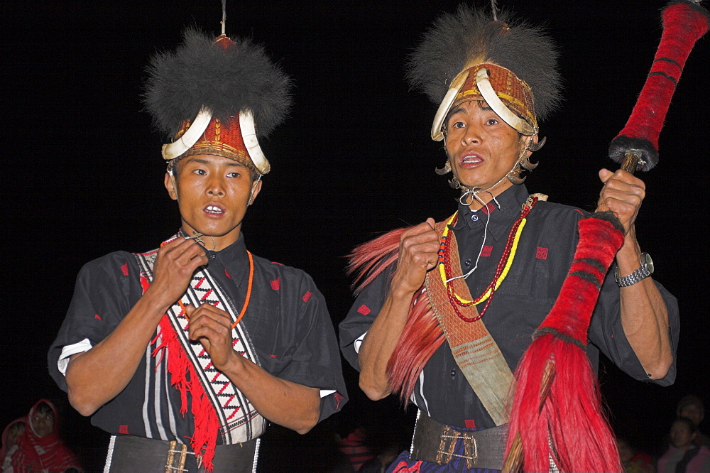 Naga men dancing at Grand Finale wearing headdress made of woven cane decorated with wild boar teeth, Mithan horns (wild cow) and bear fur,  with neckband of tiger claws, Lahe village, Naga New Year Festival, Sagaing Division, Myanmar (Burma), Asia