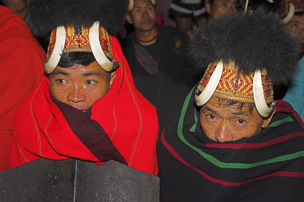 Naga men at Grand Finale (tribal dancing) wrapped up in traditional blankets wearing headdresses of woven cane with wild boars teeth and bear fur, Naga New Year Festival, Lahe village, Sagaing Division, Myanmar (Burma), Asia