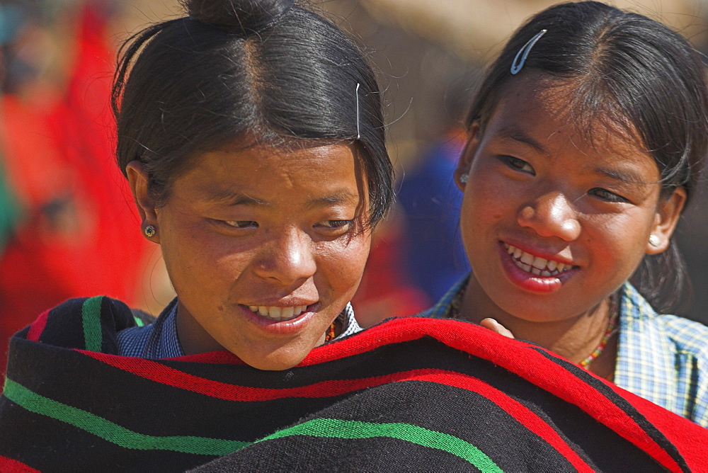 Naga (Macham tribe) girls wrapped up in their traditional blanket, Magyan Village, Sagaing Division, Myanmar (Burma), Asia