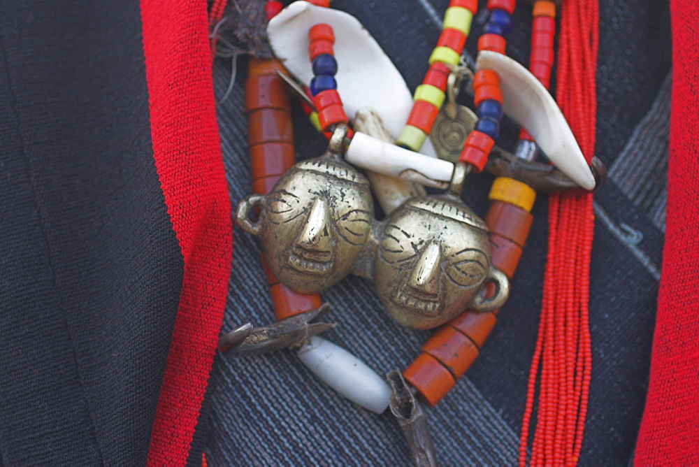 Heirloom head-hunting necklace with two brass heads indicating the owner had 'taken' two heads, Naga New Year Festival,  Naga New Year Festival, Lahe village, Sagaing Division, Myanmar (Burma), Asia