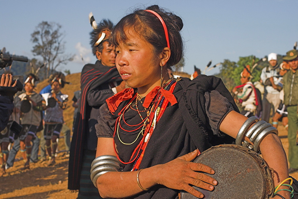 Naga lady dancing and playing drum, Naga New Year Festival, Sagaing Division, Lahe village, Myanmar (Burma), Asia