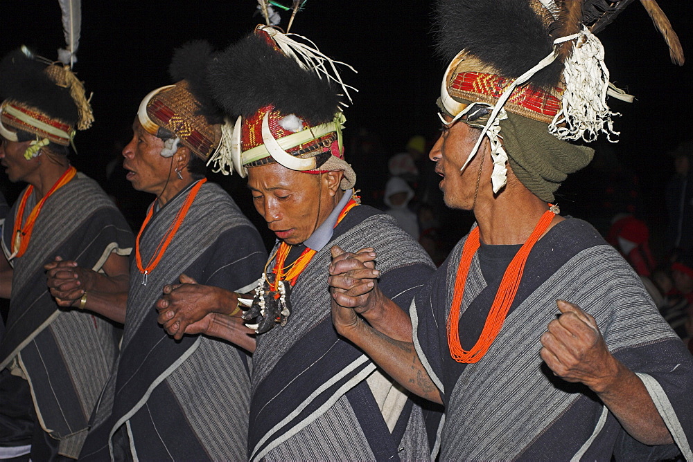 Naga man wearing tiger jaw necklace and headdress made of cane decorated with wild boar teeth and bear fur, dancing at grand finale, Naga New Year Festival, Lahe village, Sagaing Division, Myanmar (Burma), Asia