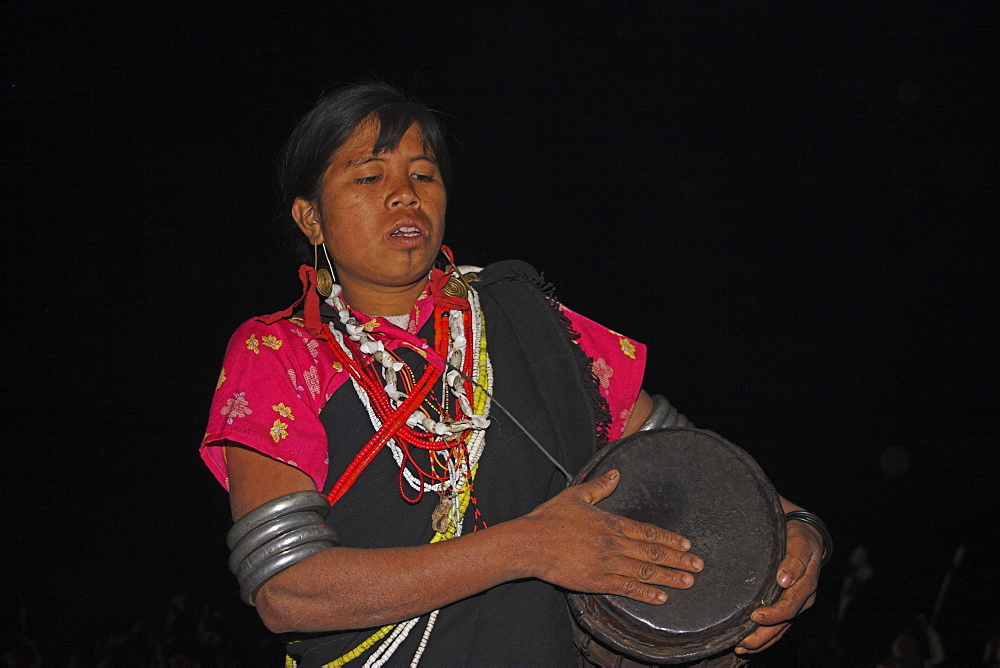 Naga lady dancing and playing drum, Naga New Year festival, Lahe village, Sagaing Division, Myanmar (Burma), Asia