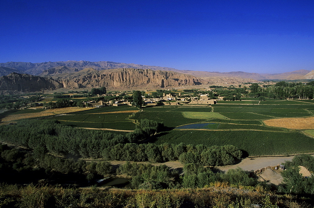 View of Bamiyan showing cliffs with two empty niches where the famous carved Buddhas stood, since destroyed by the Taliban, UNESCO World Heritage Site, Afghanistan, Asia