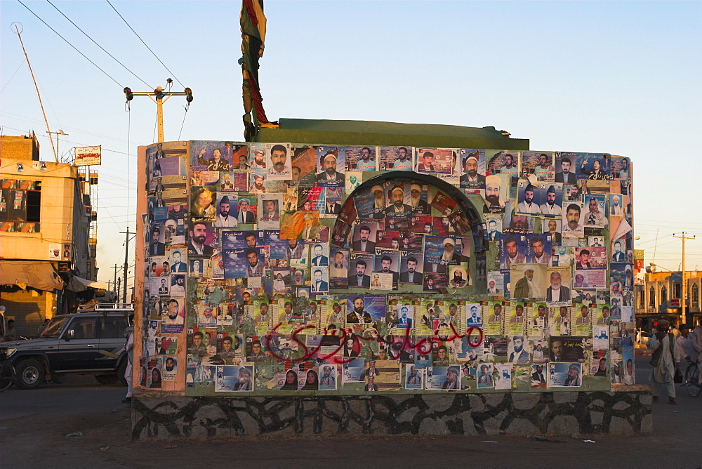 Pictures of election candidates stuck on building in midddle of street, Herat, Herat Province, Afghanistan, Asia