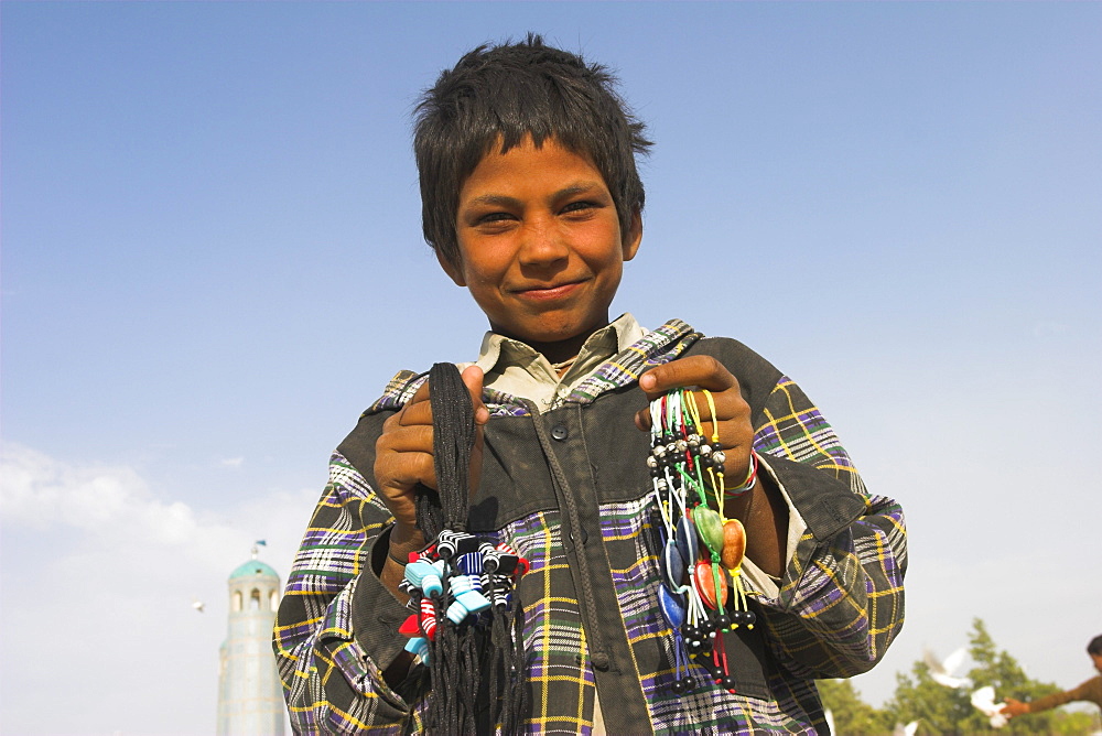 Street boy selling necklaces at the Shrine of Hazrat Ali, Mazar-I-Sharif, Balkh province, Afghanistan, Asia