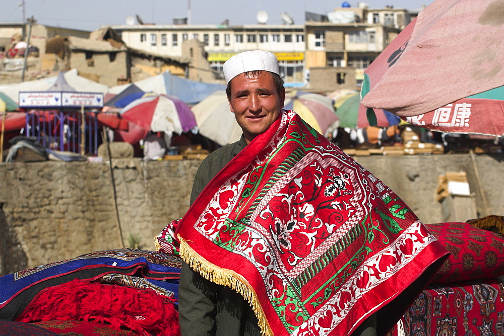 Man selling rugs on banks of Kabul river, Central Kabul, Afghanistan, Asia