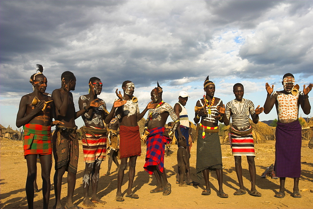 Karo people with body painting, made from mixing animal pigments with clay, dancing, Kolcho village, Lower Omo valley, Ethiopia, Africa