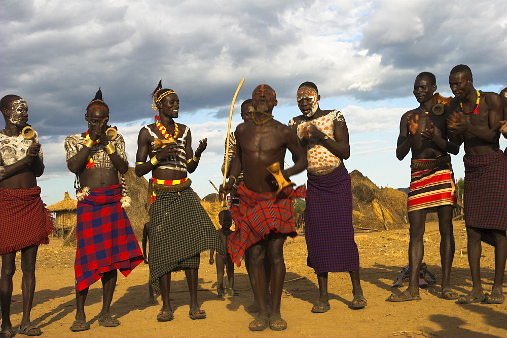 Karo people with body painting, made from mixing animal pigments with clay, dancing, Kolcho village, Lower Omo Valley, Ethiopia, Africa