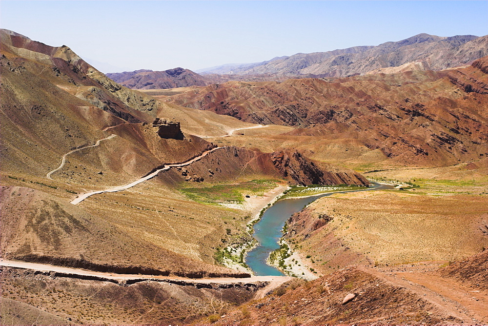 Hari Rud river flowing through fertile valley at base of red rock mountains, between Jam and Chist-I-Sharif, Ghor (Ghowr) province, Afghanistan, Asia