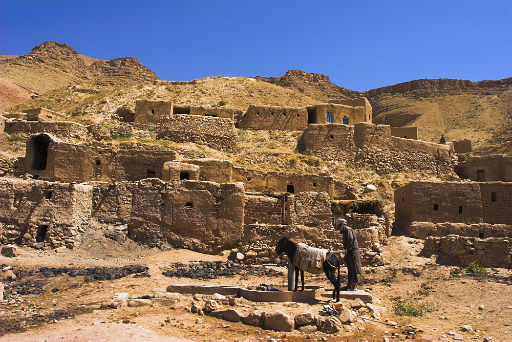 Man and donkey at well, between Herat and Maimana, after Subzak pass, Afghanistan, Asia