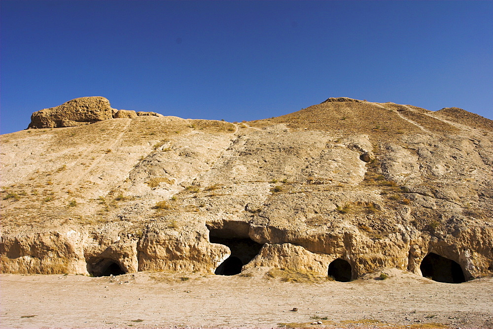 Buddhist caves, living quarters of the monks, in rock-carved stupa-monastery complex dating from the Kushano-Sasanian period, Takht-I-Rustam (Rustam's Throne), near Haibak, Samangan Province, Afghanistan, Asia