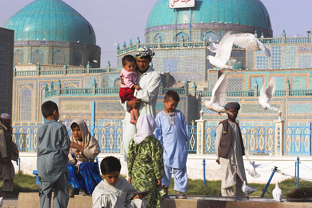 Family feeding the famous white pigeons, Shrine of Hazrat Ali, Mazar-I-Sharif, Afghanistan, Asia