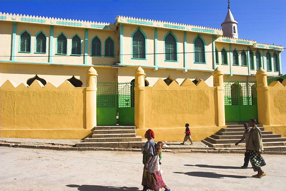 People walking past Jamia Mosque, built in the 16th century, Old Town, Harar, Ethiopia, Africa