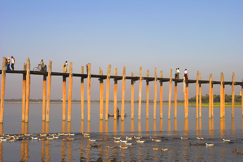 People crossing U Bein's Bridge, Taugthaman Lake, Amarapura, Mandalay, Myanmar (Burma), Asia