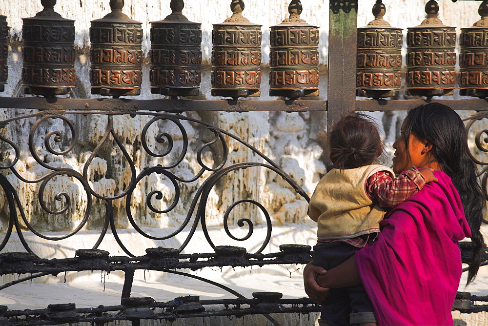 Pilgrim makes clockwise circumambulations of the stupa, Swayambhunath Stupa (Monkey Temple), Kathmandu, Nepal, Asia