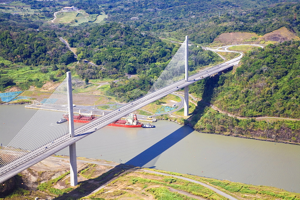 Container ship going under Centenario Bridge (Puente Centenario) and the Panama Canal , Panama City, Panama, Central America