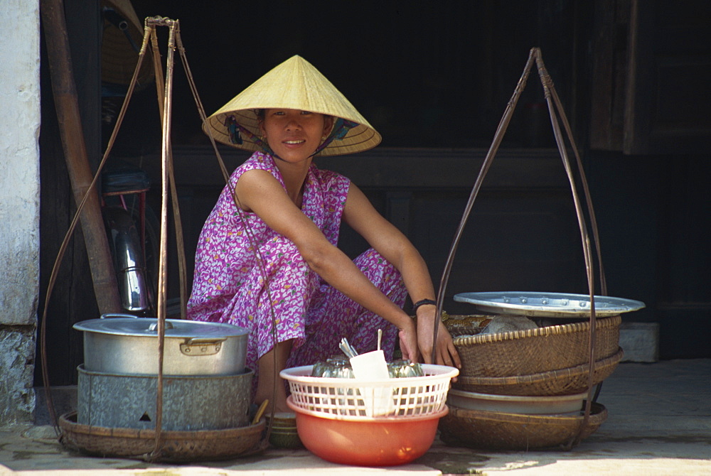 Woman street vendor in straw hat on the pavement in Hanoi, Vietnam, Indochina, Southeast Asia, Asia