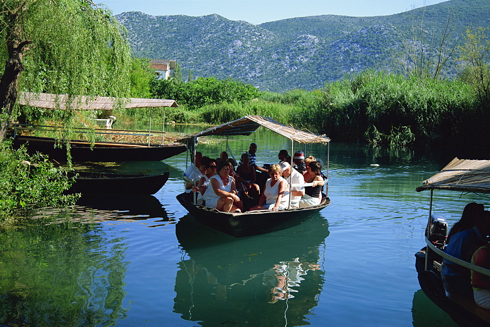 Tourists in local boats, Neretva Delta Valley, Croatia, Europe