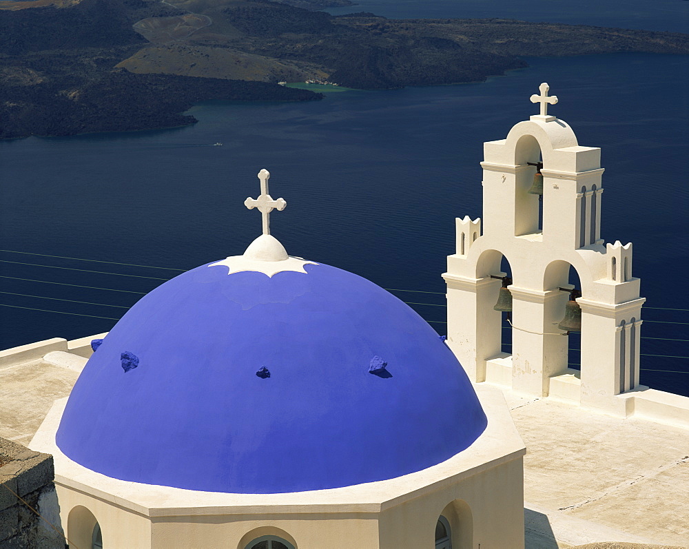 Close-up of the blue dome and bell tower of the Agiou Mina Church, high above the sea at Firostephani near Fira Town, Santorini (Thira), Cyclades Islands, Greek Islands, Europe