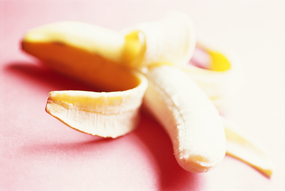 Close-up of a partly peeled banana