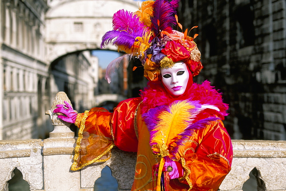 Portrait of a person dressed in mask and costume posing in front of the Bridge of Sighs, Venice Carnival, Venice, Veneto, Italy, Europe