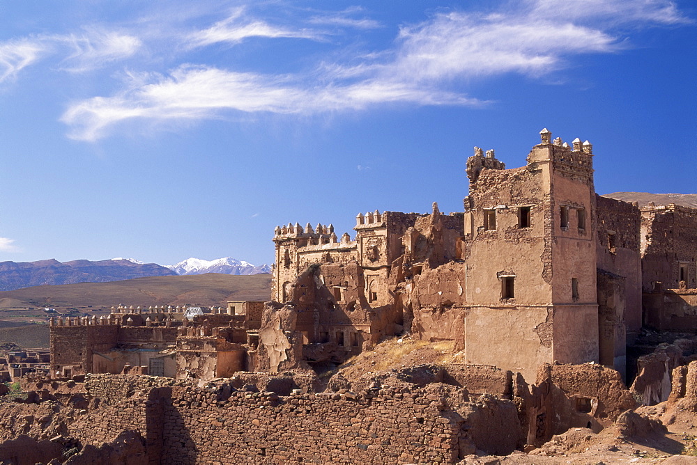 Ruins of Glaoui kasbah at Telouet, with the High Atlas mountains in the distance, Telouet, near Ouarzazate, Morocco, North Africa, Africa