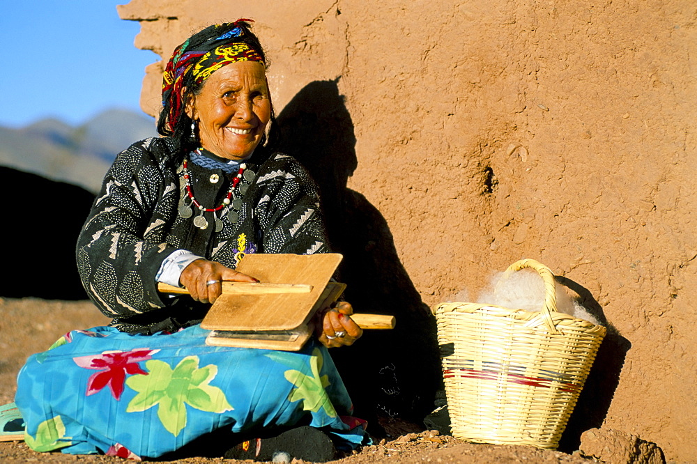 Berber woman in traditional clothing, carding wool, Telouet, near Ouarzazate, Morocco, North Africa, Africa