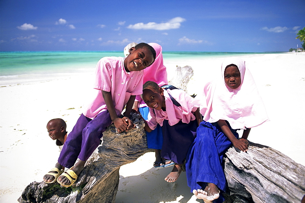 Young Muslim children in school uniform on beach at Jambiani, Zanzibar, Tanzania, Africa