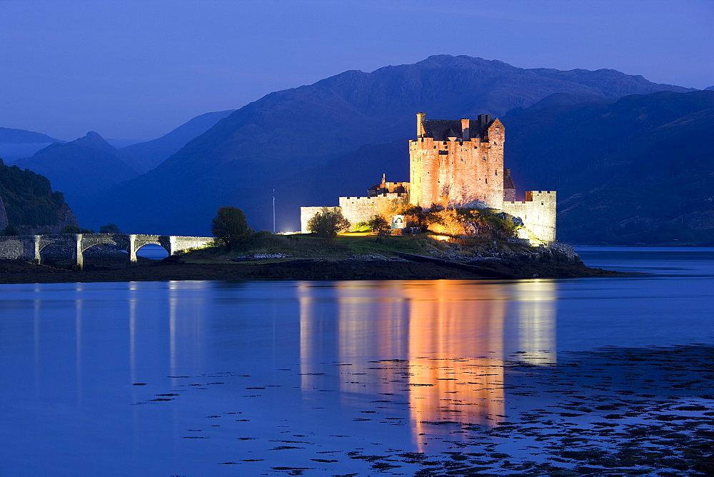 Eilean Donan Castle floodlit at night on Loch Duich, near Kyle of Lochalsh, Highland, Scotland, United Kingdom, Europe