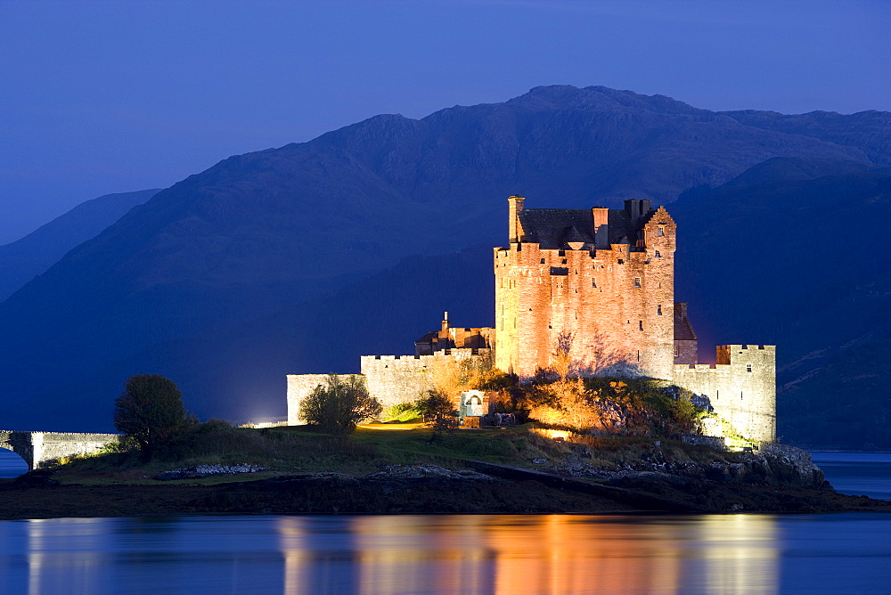 Eilean Donan Castle floodlit at night on Loch Duich, near Kyle of Lochalsh, Highland, Scotland, United Kingdom, Europe