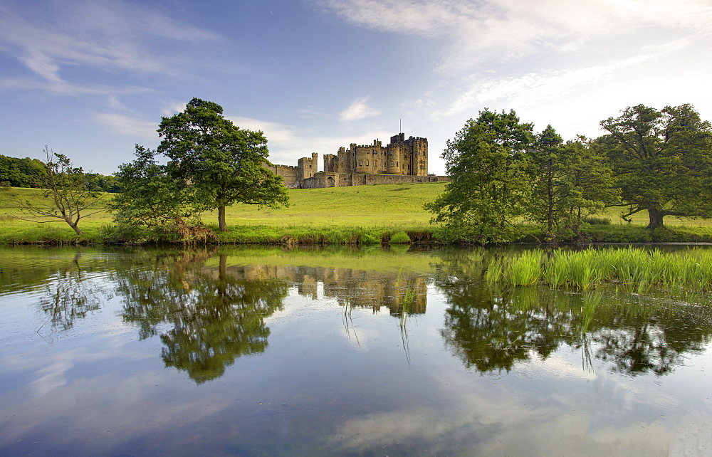 Alnwick Castle reflecting in River Aln, Alnwick, Northumberland, England, United Kingdom, Europe