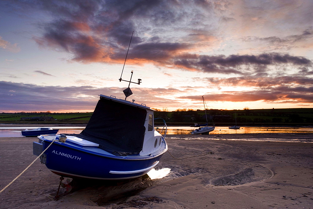 Fishing boat on the Aln Estuary at sunset, Alnmouth, near Alnwick, Northumberland, England, United Kingdom, Europe