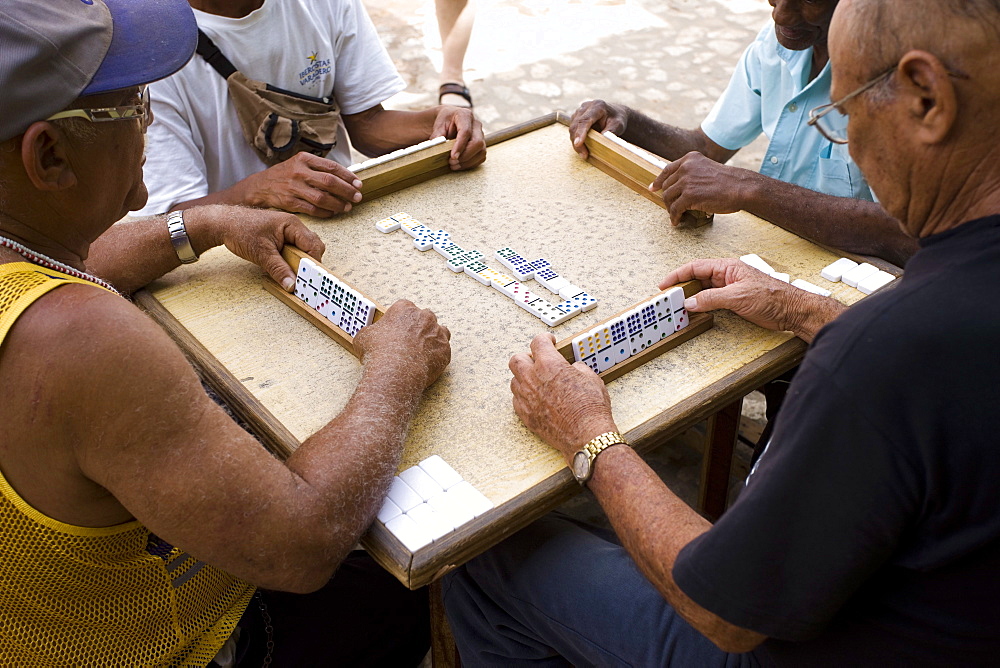 Old men playing dominos on street in Trinidad, Cuba, West Indies, Central America