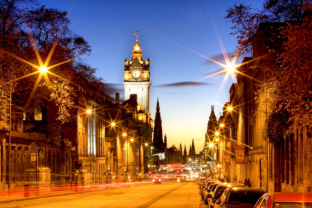 View along Waterloo Place at night towards Princes Street and the floodlit tower of the Balmoral Hotel, Edinburgh, Lothian, Scotland, United Kingdom, Europe