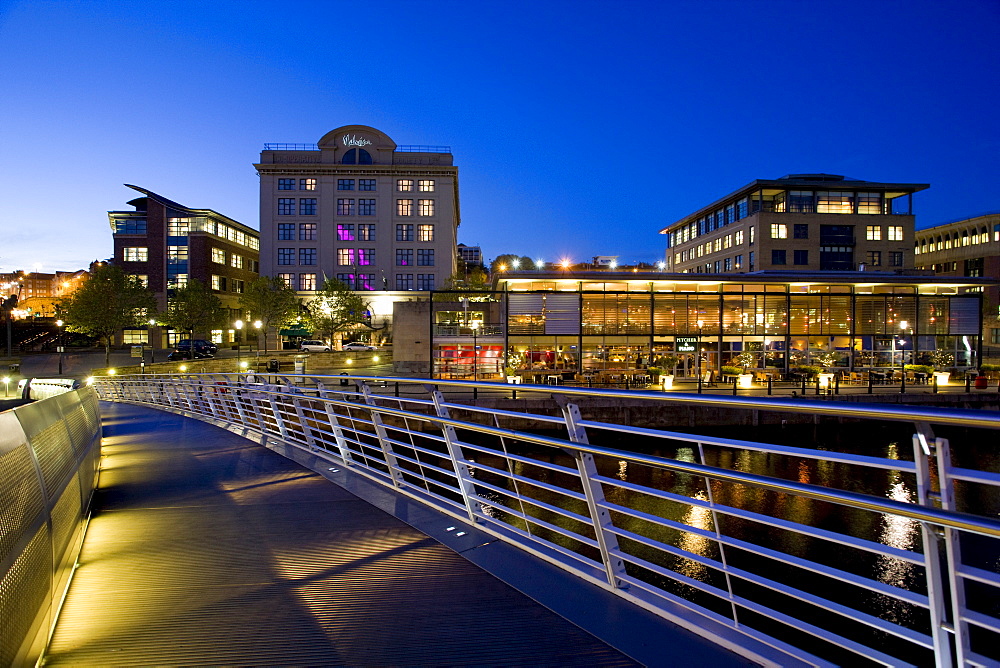 View from Gateshead Millennium Bridge at night towards buildings on Newcastle quayside including Hotel Malmaison and The Pitcher and Piano bar, Newcastle-upon-Tyne, Tyne and Wear, England, United Kingdom, Europe