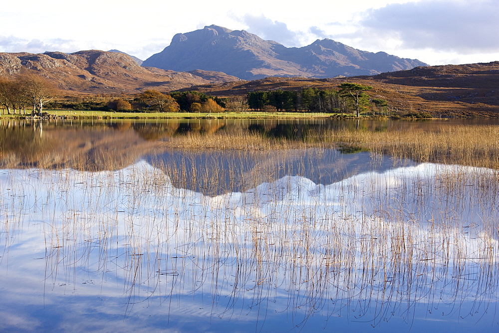 Loch Nan Dailthean with reflections and Beinn Airigh Charr rising in background, near Tournaig, Wester Ross, Highlands, Scotland, United Kingdom, Europe