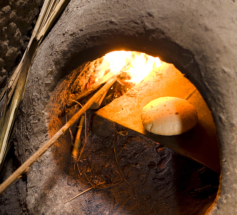 Freshly-baked bread in a traditional communal clay oven in the town of Merzouga, Morocco, North Africa, Africa