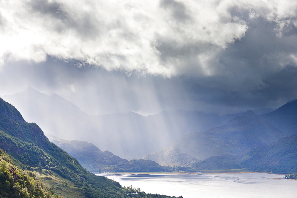 View from Carr Brae towards head of Loch Duich and Five Sisters of Kintail with rays of sunlight bursting through sky, Highlands, Scotland, United Kingdom, Europe