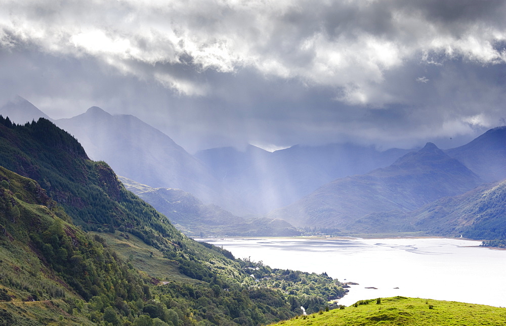 View from Carr Brae towards head of Loch Duich and Five Sisters of Kintail with sunlight bursting through sky, Highlands, Scotland, United Kingdom, Europe