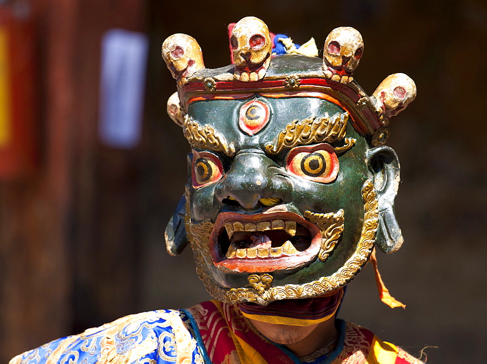 Buddhist monk wearing colourful carved wooden mask at the Tamshing Phala Choepa Tsechu, near Jakar, Bumthang, Bhutan, Asia