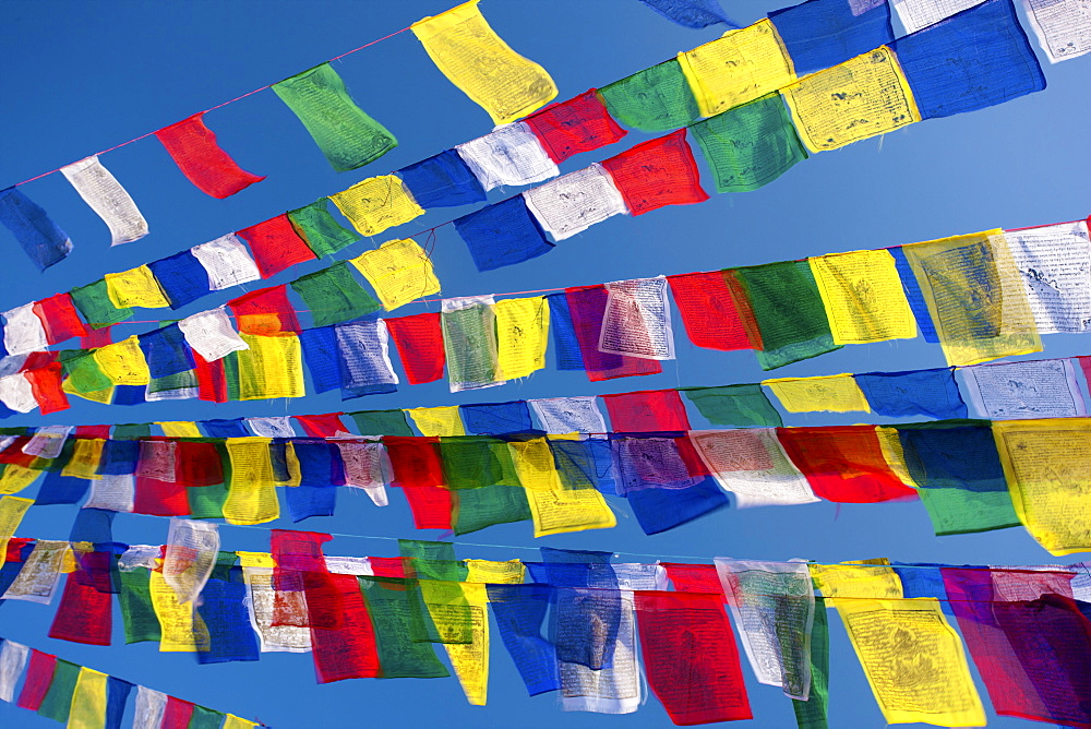 Colourful prayer flags against clear blue sky at Bodhnath Stupa (Boudhanth) (Boudha), one of the holiest Buddhist sites in Kathmandu, Kathmandu, Nepal, Asia