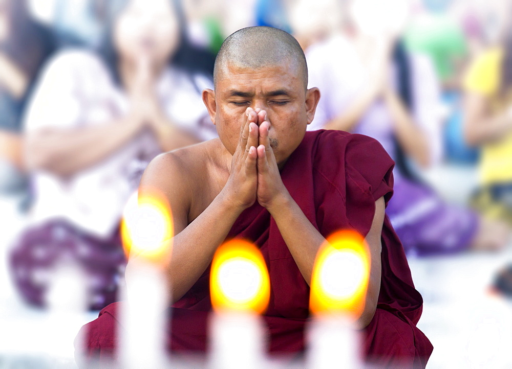 Buddhist monk praying at Shwedagon Paya (Shwedagon Pagoda), Yangon (Rangoon), Myanmar (Burma), Asia